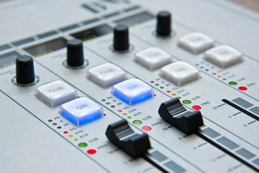 Detailed view of audio mixing console with knobs and buttons for music and sound control.