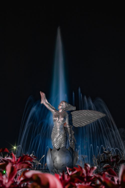 A statue of a fairy with water flowing from it