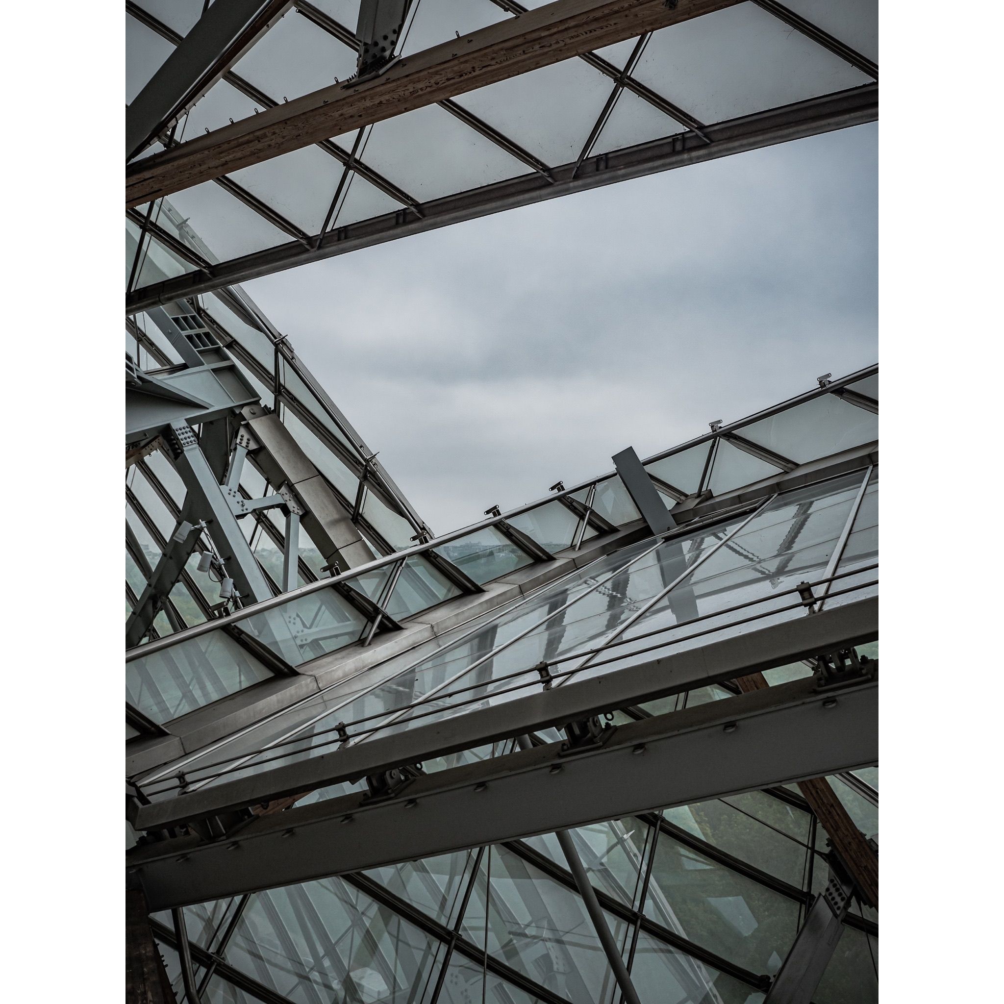 Low angle modern facade with glass and steel in Paris.