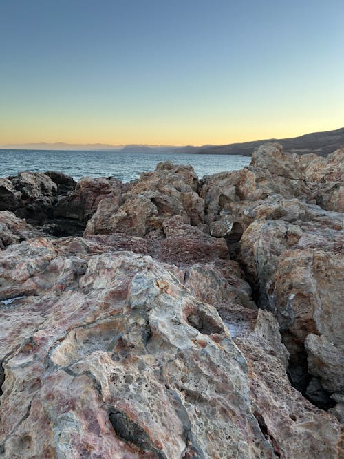 Rocks on Sea Shore at Sunset