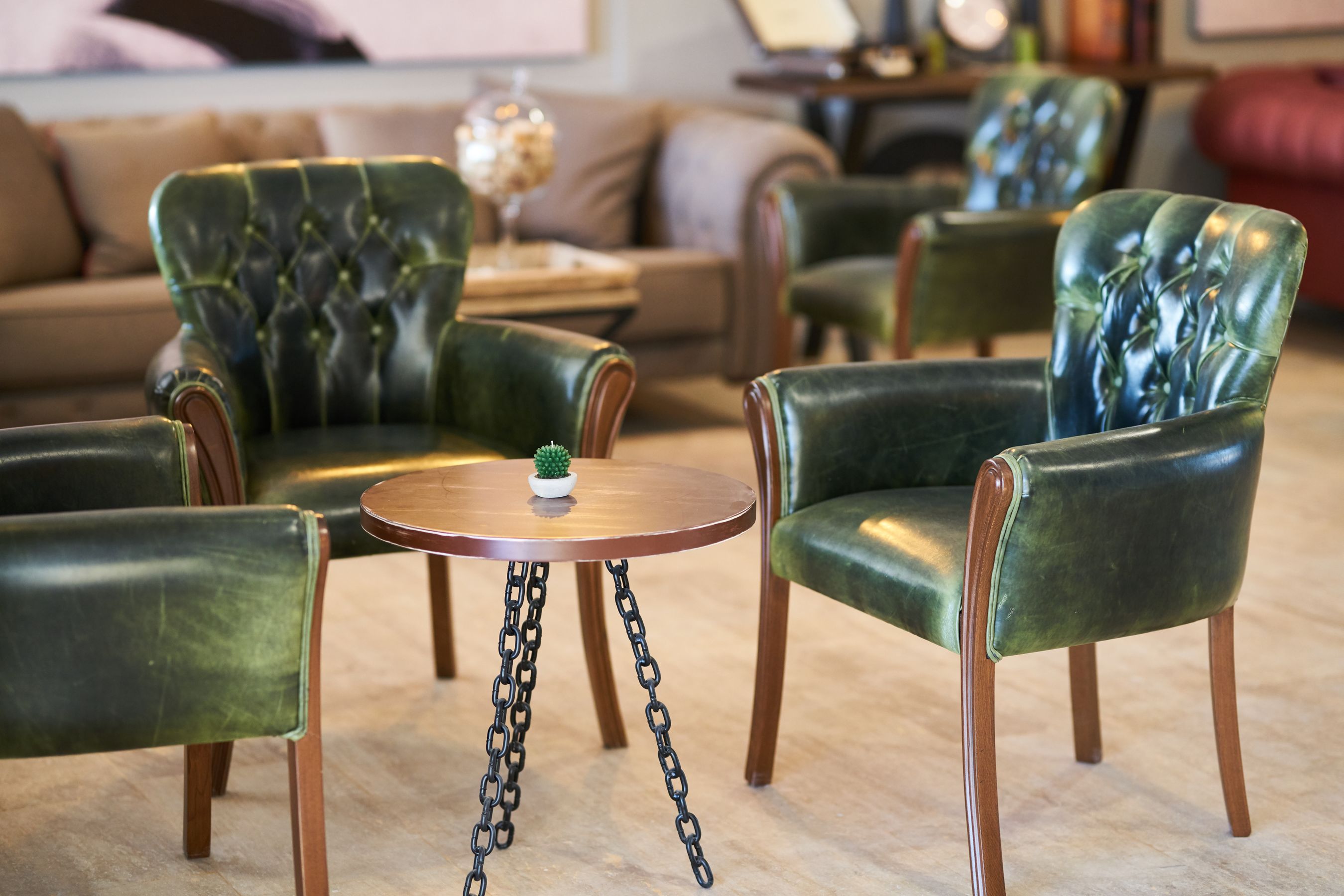 Two green leather armchairs in a contemporary room