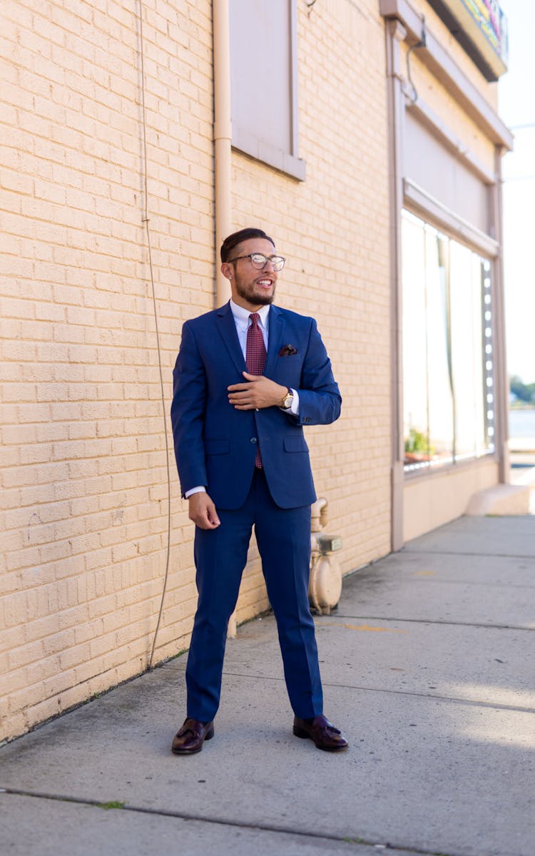 Man In Suit Standing On Sidewalk