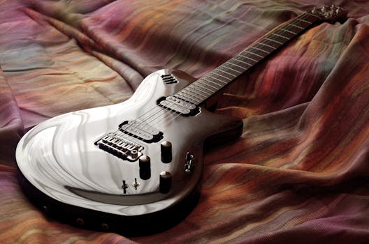 Sleek electric guitar resting on colorful fabric, captured with artistic lighting.