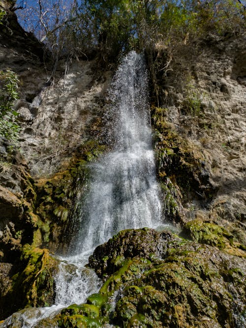 Sunlit Waterfall on Rocks