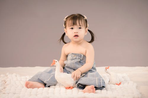 Girl Sitting with Toys