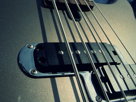 Detailed view of guitar strings and pickups highlighting texture and design.