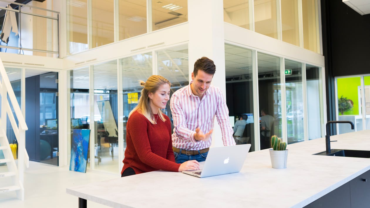 Photo of a Man and Woman Using a Laptop Computer 