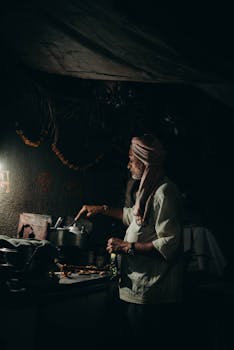 Elderly man in Nagpur cooks traditional food, highlighting rich culture and tradition.