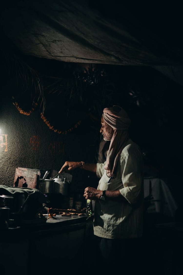 Man In A Turban Cooking Traditional Food 