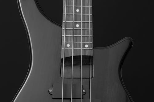 Close Up Photo of Gray Electric Bass Guitar