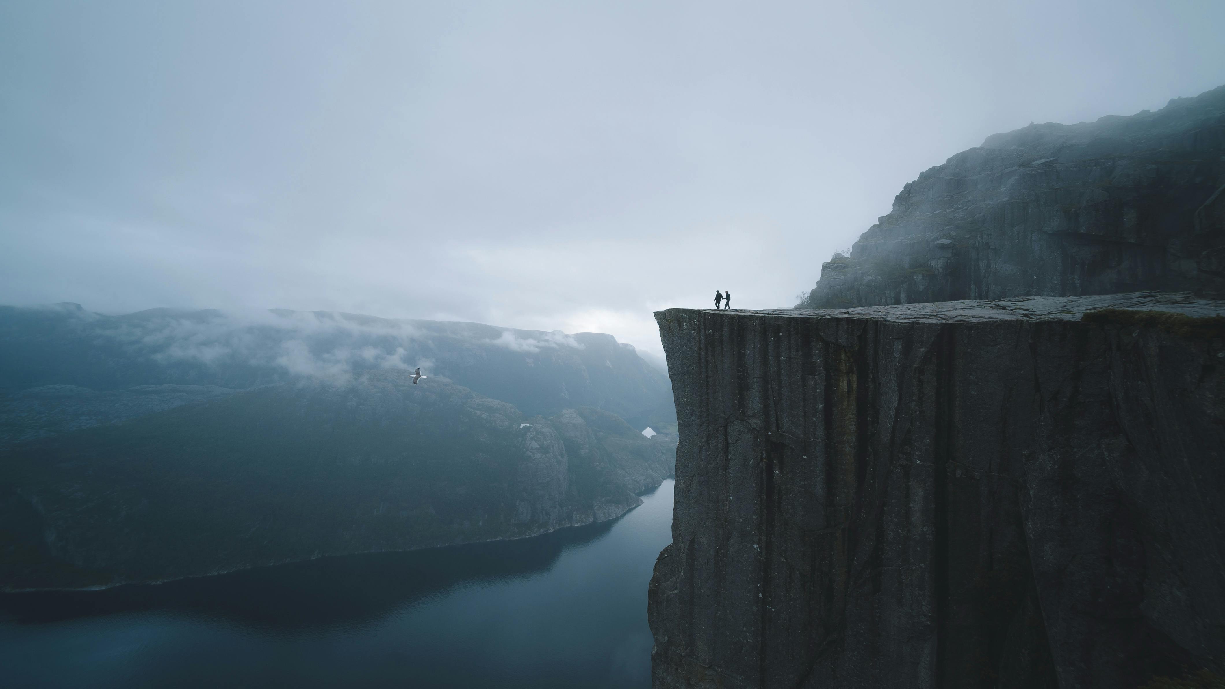 two people on mountain cliff