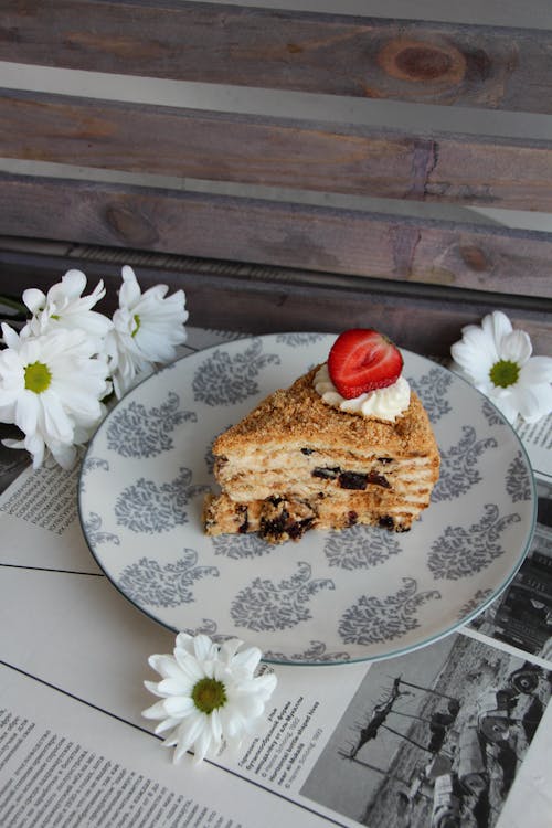 A Slice of Layer Cake with Cream and Strawberries