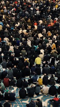 A large group of worshippers praying inside a mosque in Istanbul, Turkey.