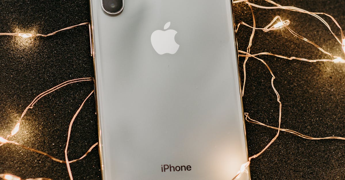 Silver Iphone X Lying on Pre-lit String Lights