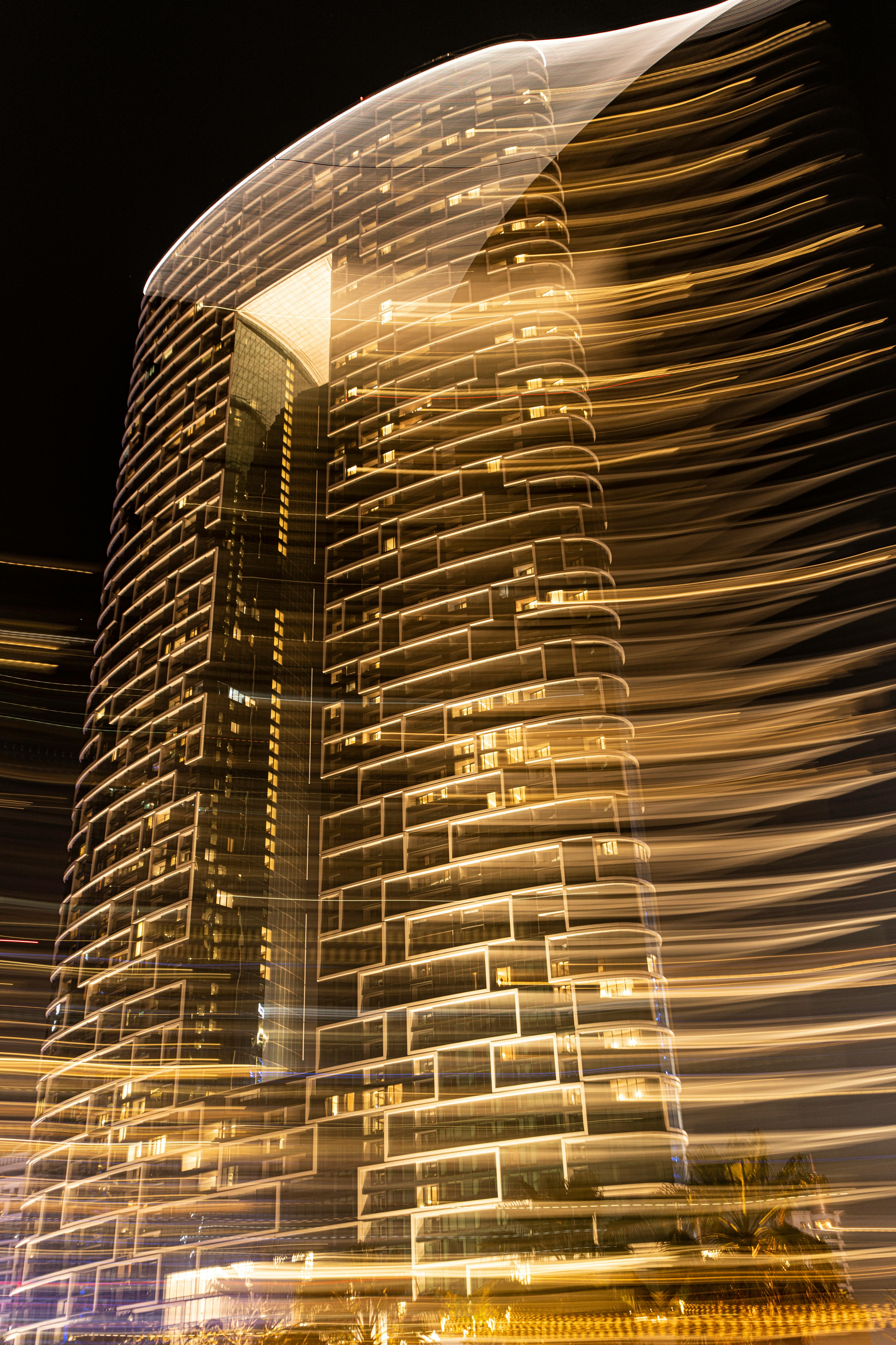 Captivating long exposure night shot of a hotel in Dubai with golden lights.
