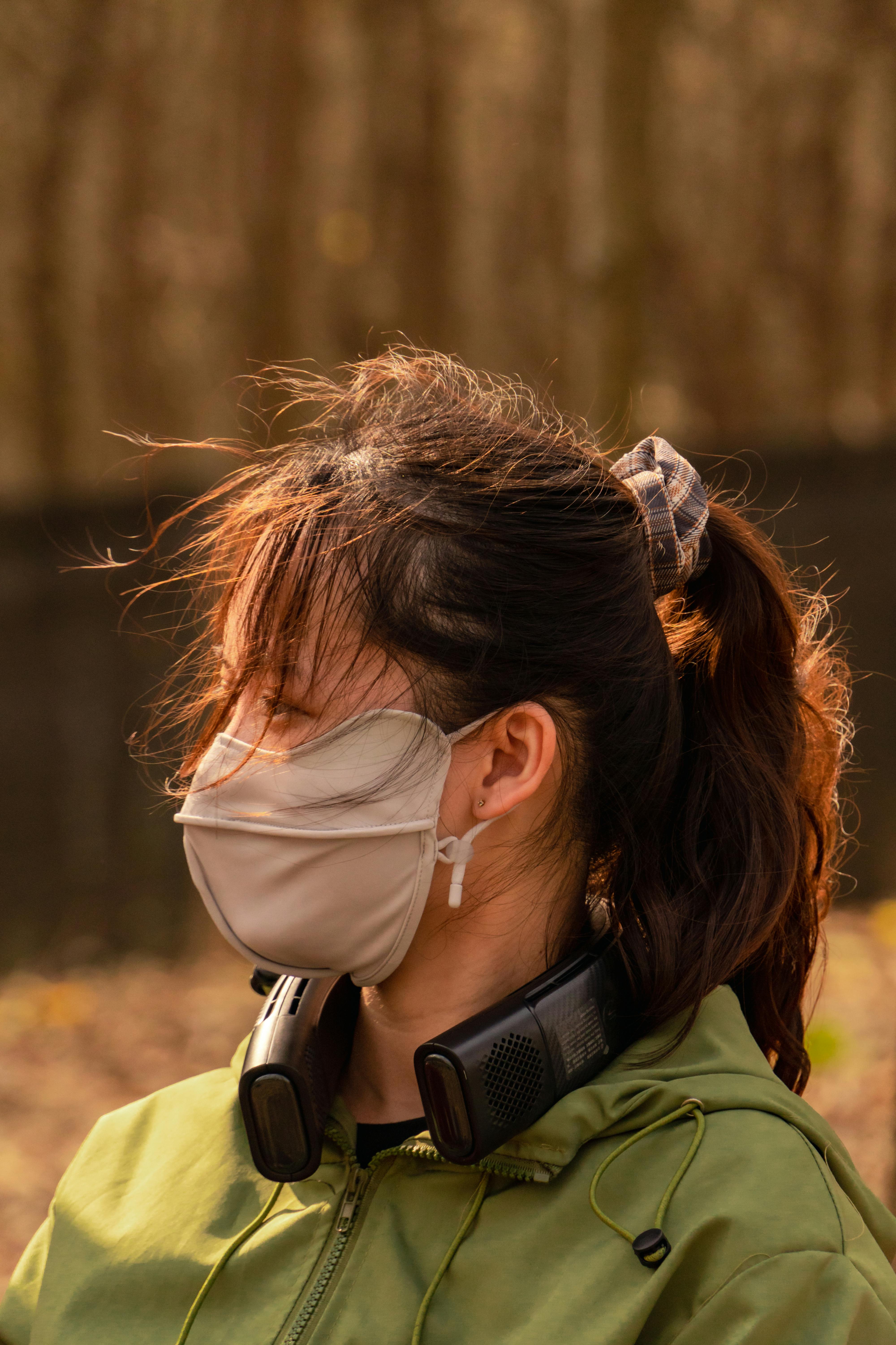 a woman wearing a face mask in the woods