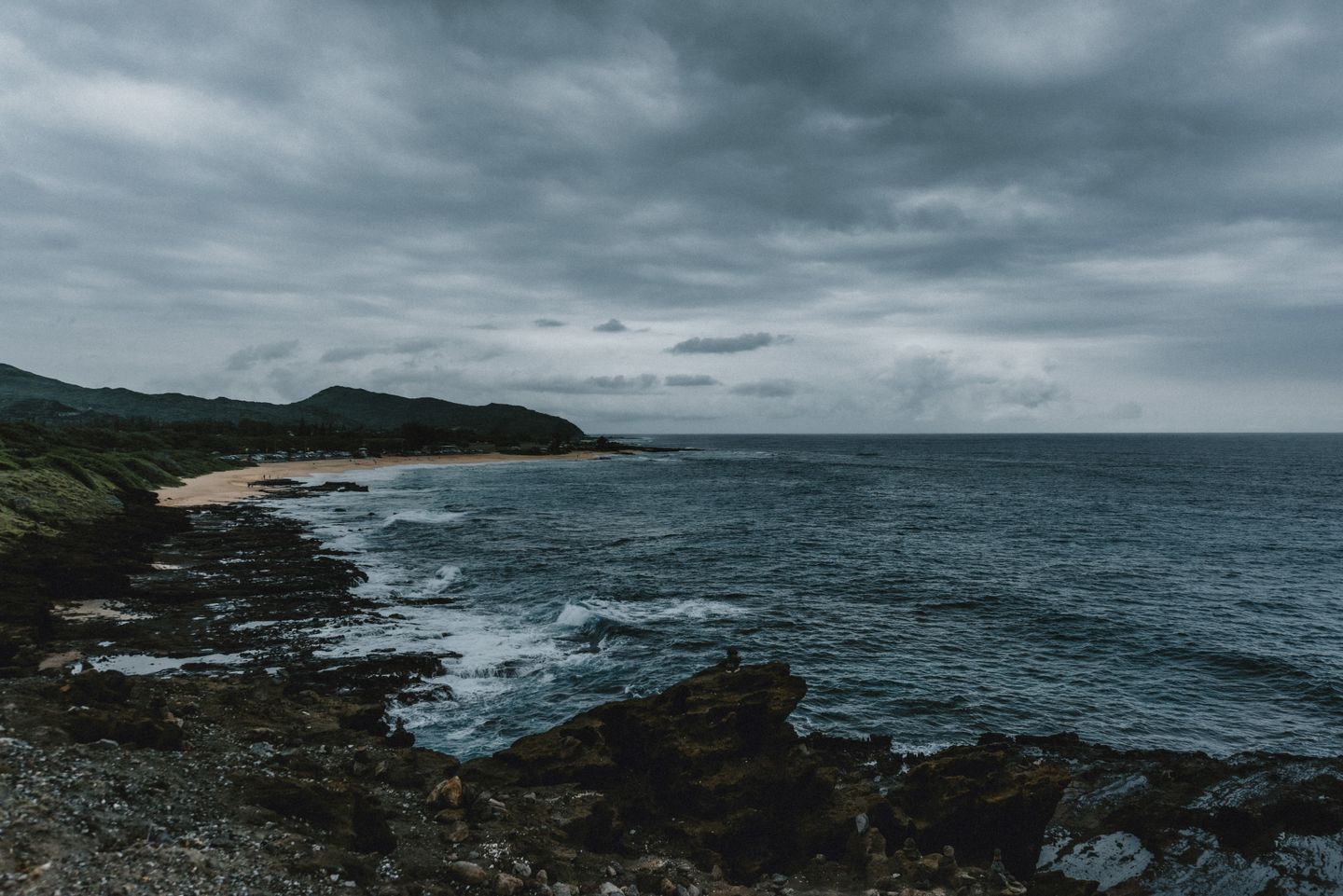 Storm clouds building over a rocky Hawaiian shoreline