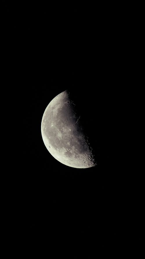 Free Stunning view of a half moon captured in a dark, clear night sky. Stock Photo