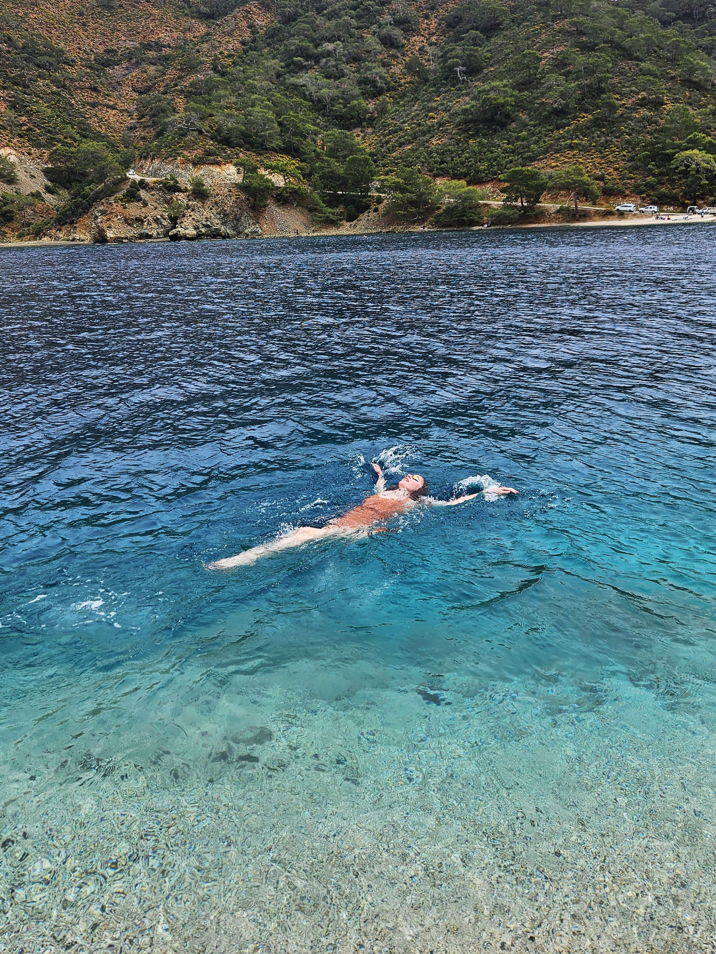 A relaxing swim in clear blue waters, perfect for a peaceful getaway from the city.
