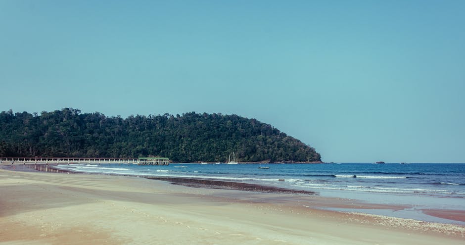 Idyllic beach on Tioman Island, Malaysia, showcasing tranquil seas and lush greenery.