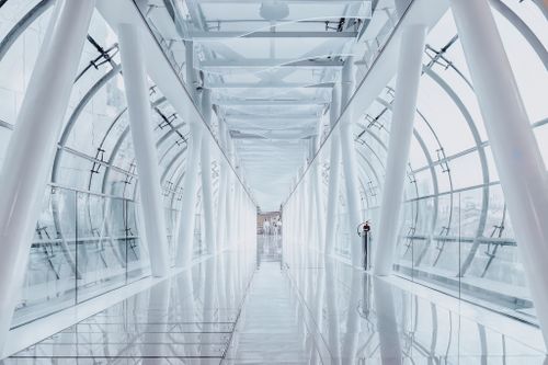 Free Modern glass corridor in Singapore with sleek architecture and urban design. Stock Photo