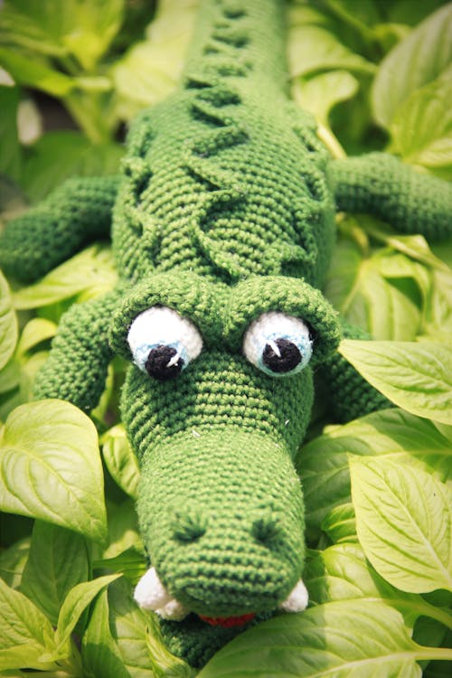 Knitted Crocodile on Green Leaves 