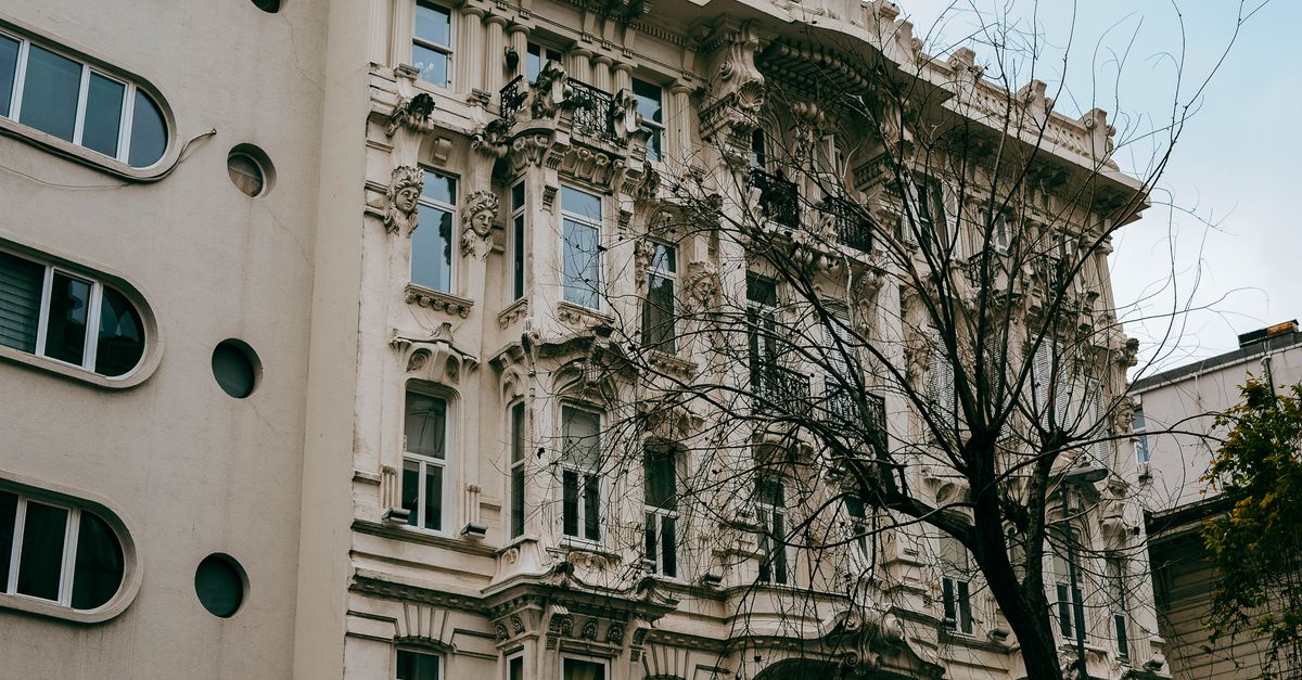 A stunning ornamental facade of a historic building showcasing intricate architectural details in an urban setting.