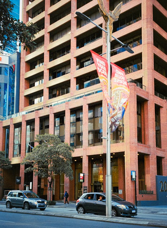 A large red brick building with a flag hanging from it