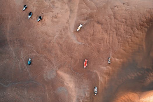 High Angle Photo of Boats During Low Tide