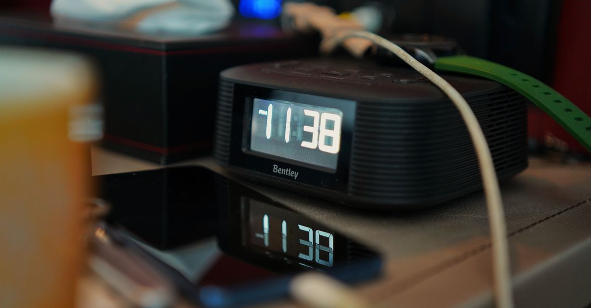 A split clock showing 8 PM on one side and a diagram of brain activity dropping on the other