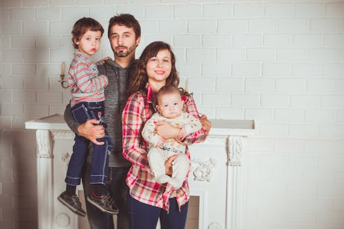 Free Standing Family Near Fireplace Stock Photo