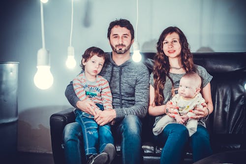 Free Family Picture on Black Couch Stock Photo