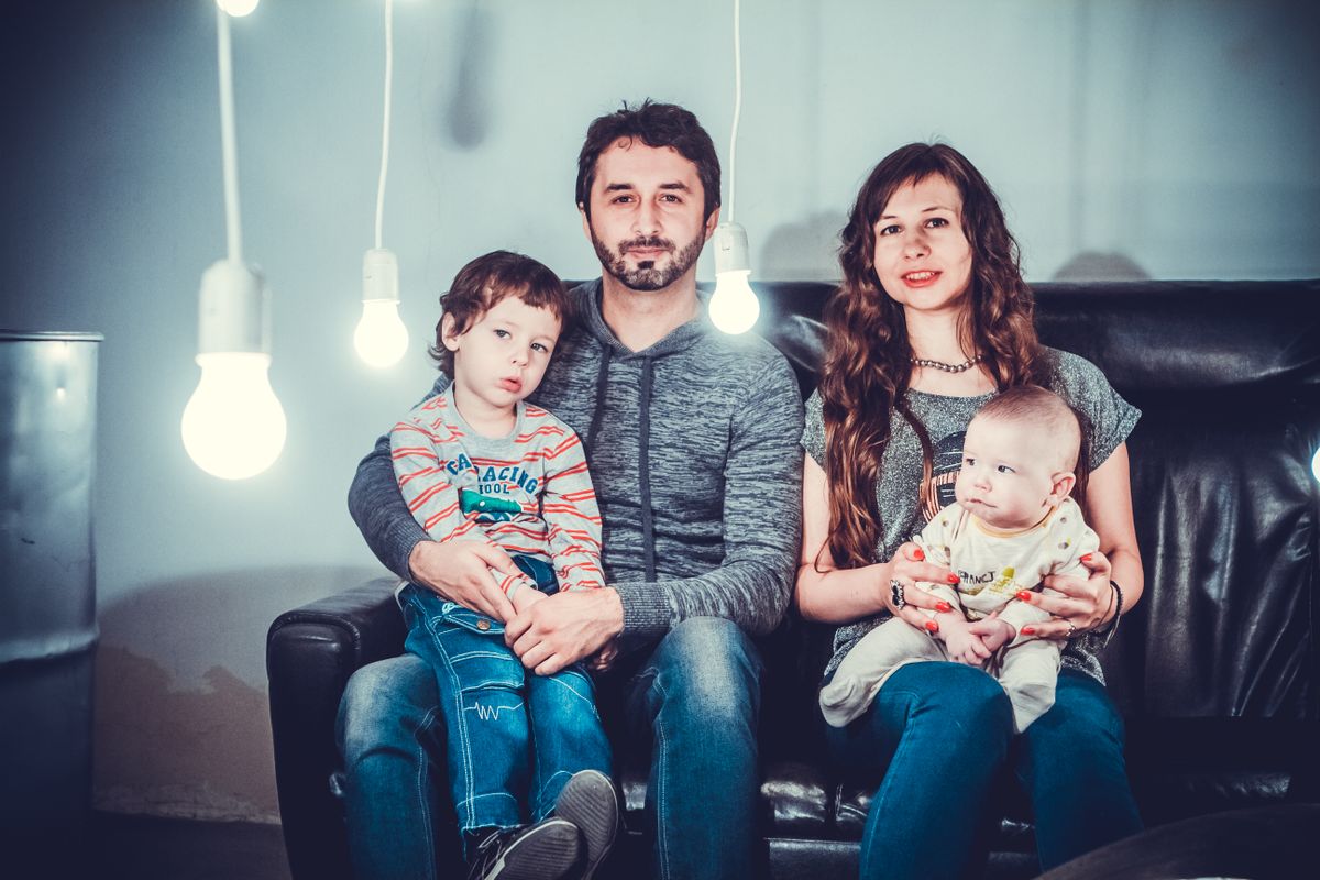 A family portrait of parents and children on a couch