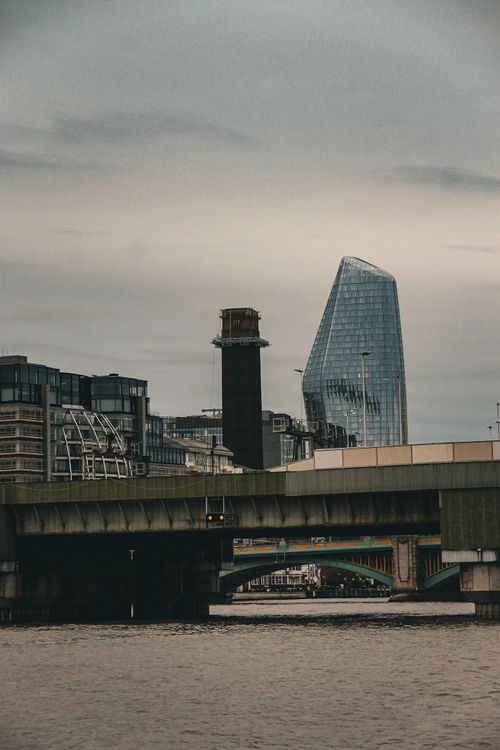Free View of a modern cityscape with a bridge and skyscraper over a river. Stock Photo