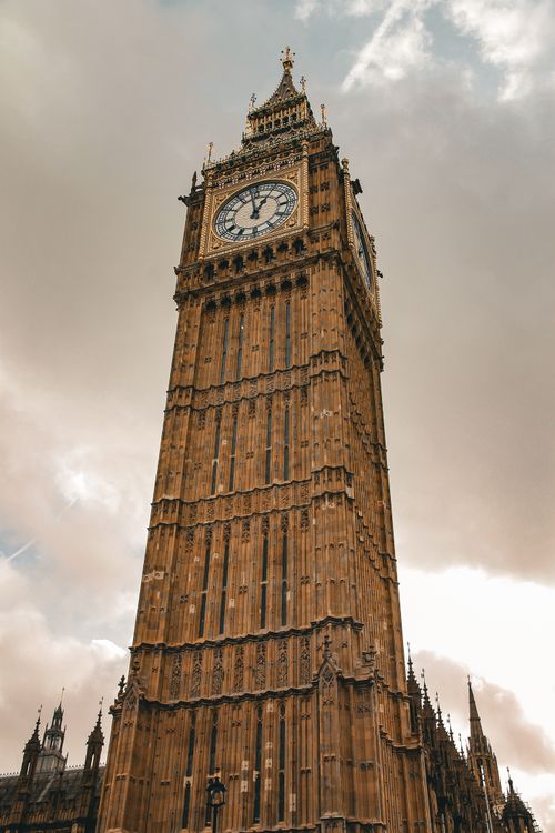 Free Stunning low angle shot of the iconic Elizabeth Tower, home to Big Ben, in London. Stock Photo