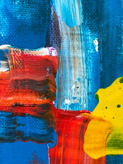 Free Close-up of colorful abstract painting with dynamic brushstrokes in blue, red, yellow. Stock Photo