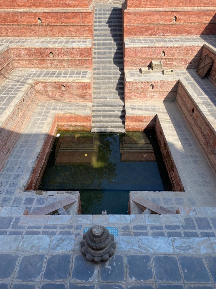 Temple With Water Pond In Center