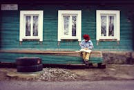 Boy Seating On Bench