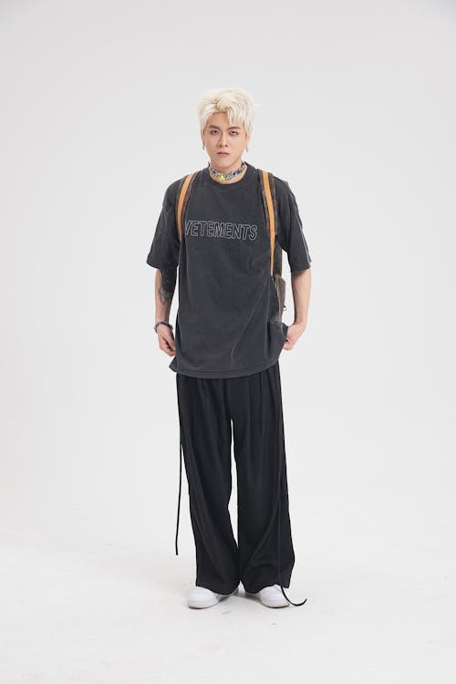 Young Man in Casual Wear Posing on White Studio Background