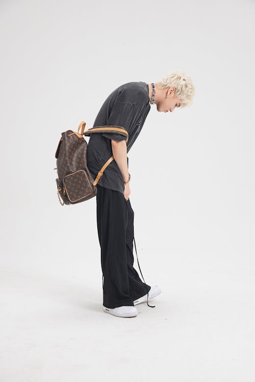 Guy in Casual Wear with Backpack Posing in Studio