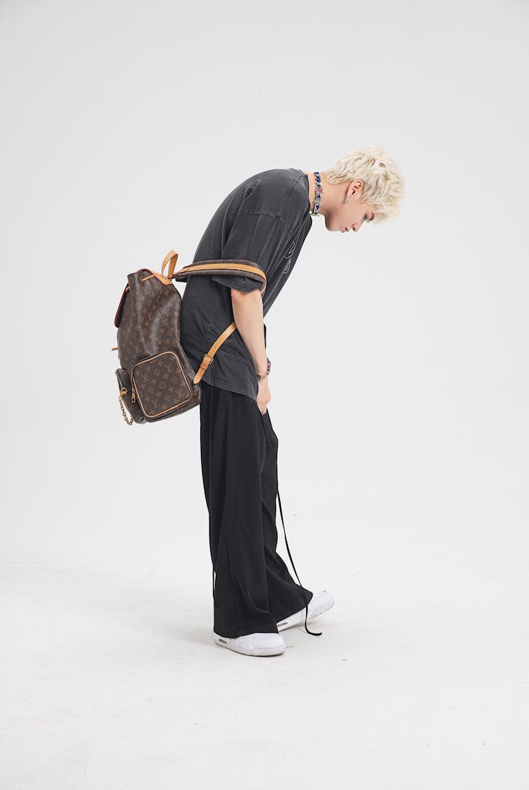 Guy In Casual Wear With Backpack Posing In Studio