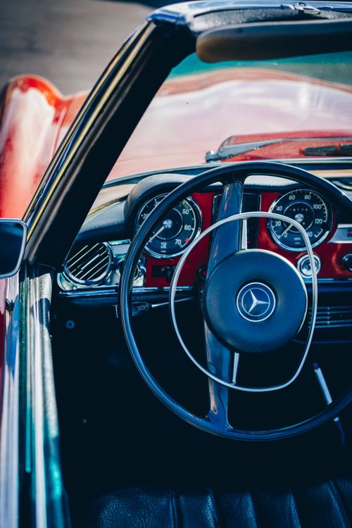 Free Explore the classic vintage interior of a Mercedes-Benz convertible featuring retro design elements. Stock Photo