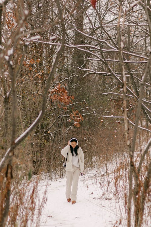 Brunette Strolling in Forest in Winter