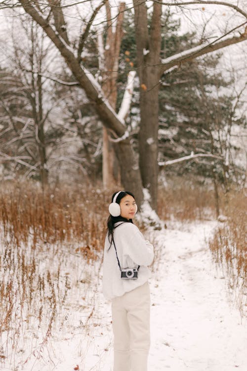 Woman Wearing Earmuffs on Winter Day