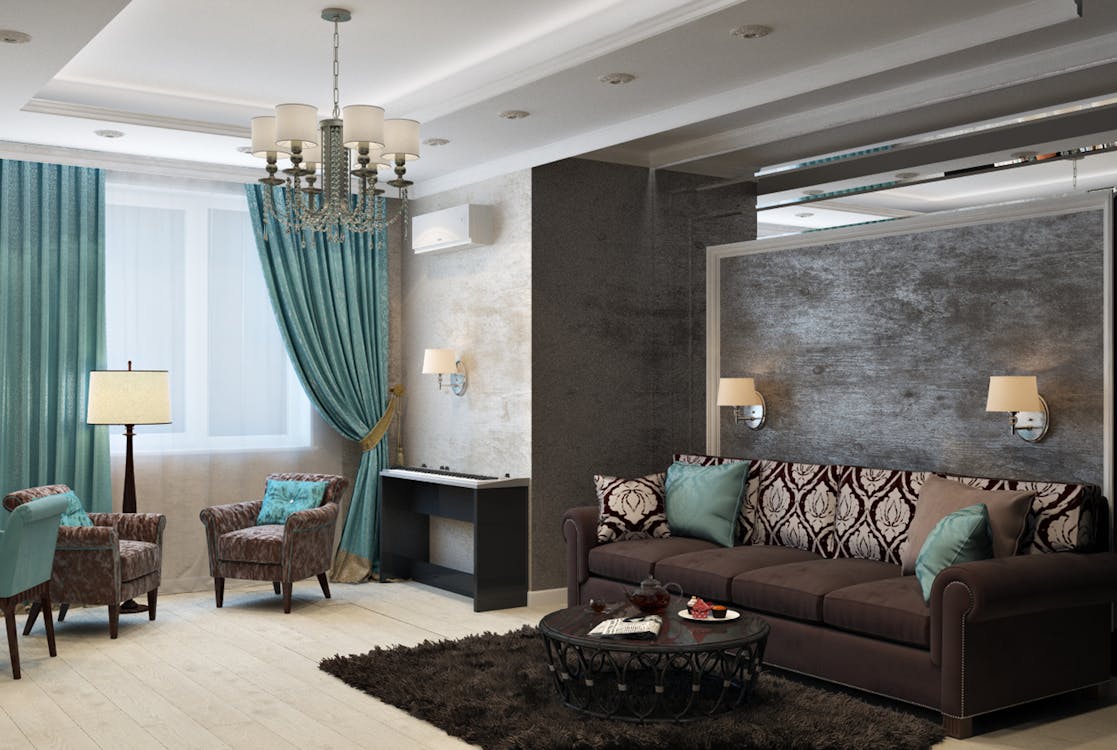 A room with teal curtains and sofas, and a dark brown rug.