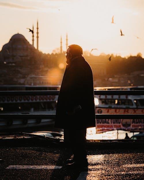 A Silhouette of a Man on a Bridge