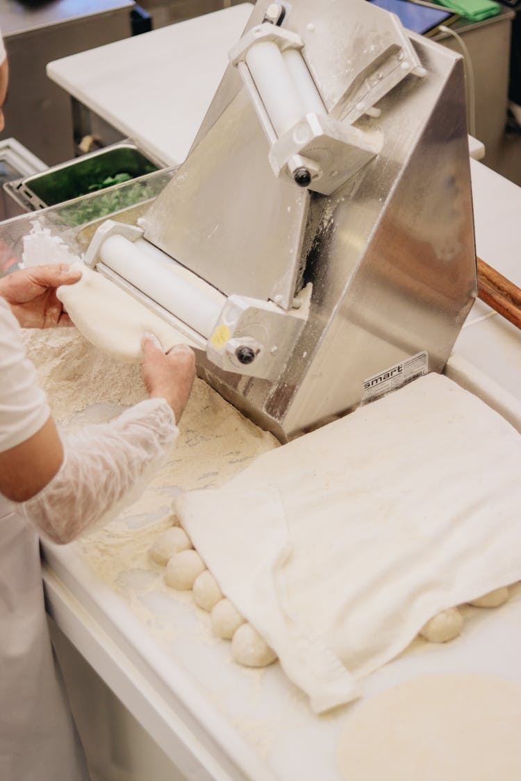 Man Working With Automatic Rolling Pin