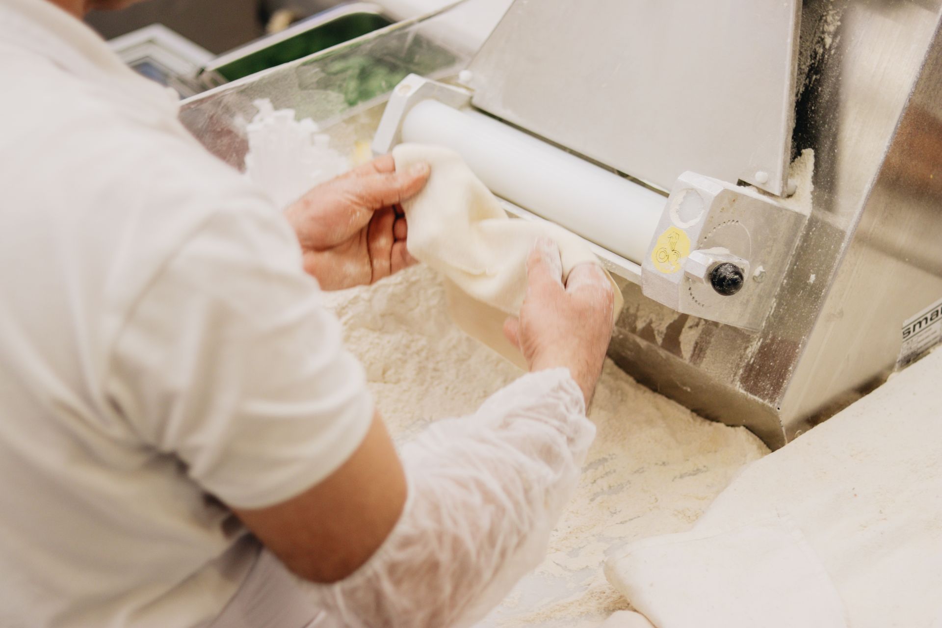 Man Working with Dough in Bakery