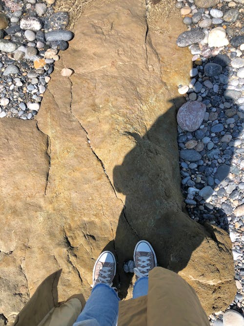 Female Legs on a Rocky Beach