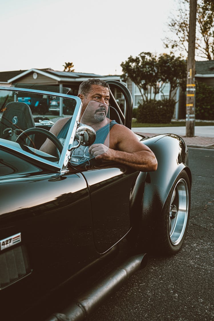 Man Sitting In A Vintage Convertible